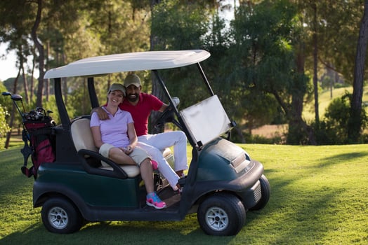 couple in buggy on golf course photo