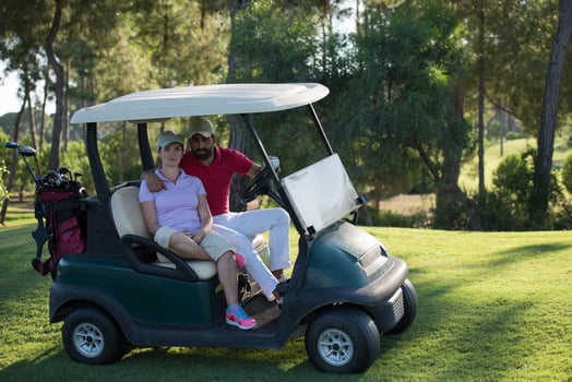 couple in buggy on golf course photo