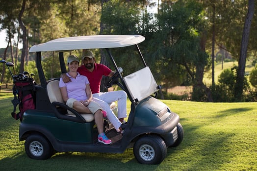 couple in buggy on golf course photo