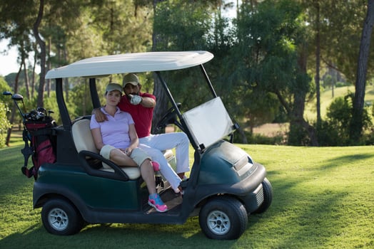 couple in buggy on golf course photo