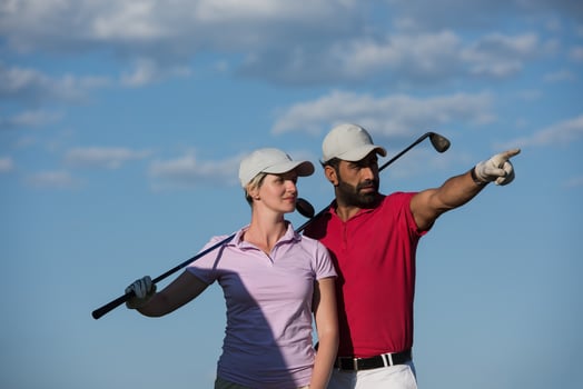 portrait of couple on golf course photo