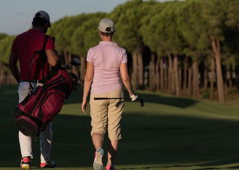 couple walking on golf course photo