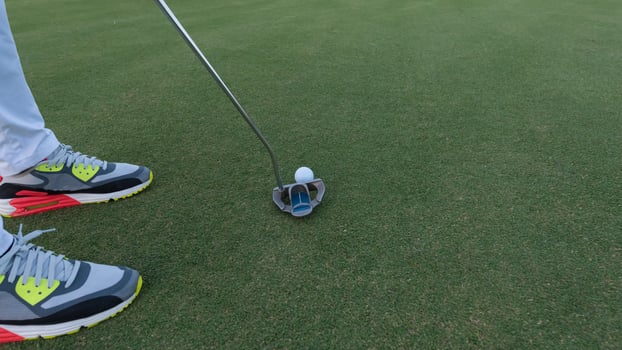 hitting golf ball to hole photo