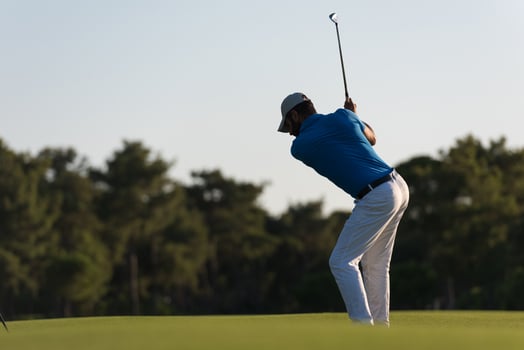 golfer hitting long shot photo