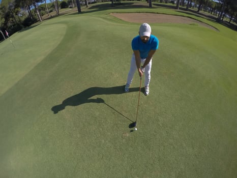 top view of golf player hitting shot photo