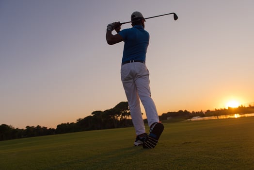 golfer hitting long shot photo