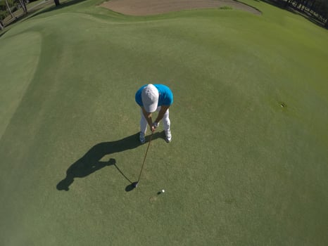 top view of golf player hitting shot photo