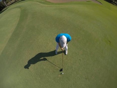 top view of golf player hitting shot photo