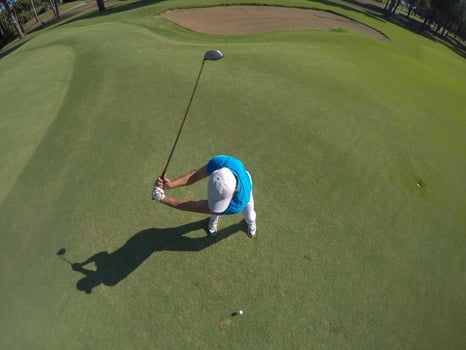 top view of golf player hitting shot photo