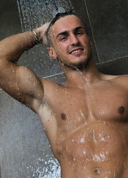good looking man under man shower photo