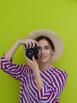 Portrait of beautiful female photographer shooting close up photo