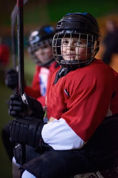 children ice hockey players on bench photo
