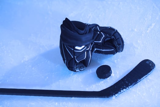 hockey sticsk and puck on ice photo
