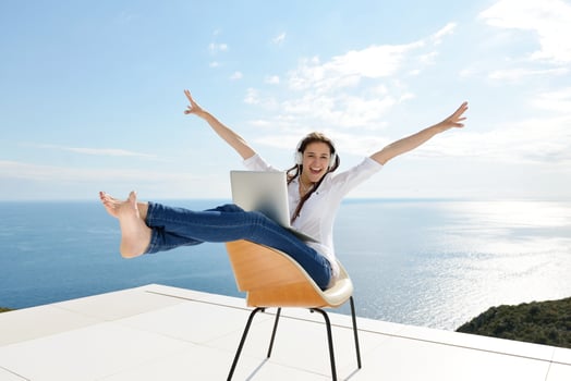 relaxed young woman at home working on laptop photo