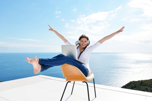 relaxed young woman at home working on laptop photo