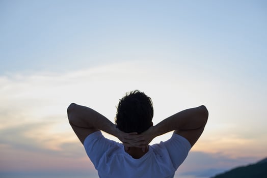 relaxed young man at home on balcony photo