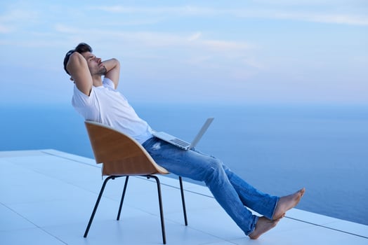 relaxed young man at home on balcony photo