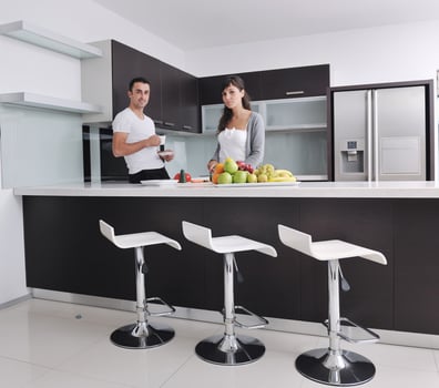 young couple have fun in modern kitchen photo