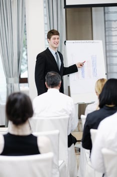 Young  business man giving a presentation on conference photo
