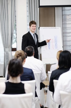 Young  business man giving a presentation on conference photo