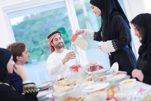 Muslim family having Iftar dinner drinking water to break feast photo