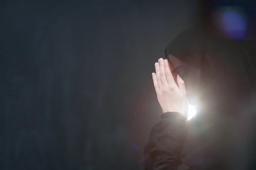 Portrait of young Muslim woman making dua photo