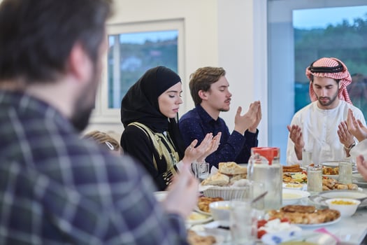 Muslim family making iftar dua to break fasting during Ramadan. photo