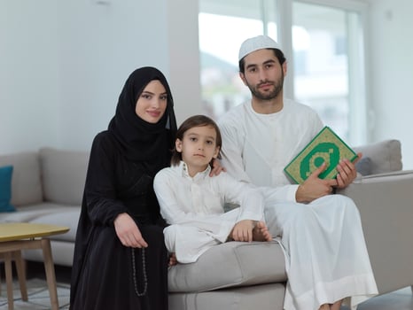 Young muslim family reading Quran during Ramadan photo
