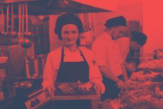 female Chef holding beef steak plate photo