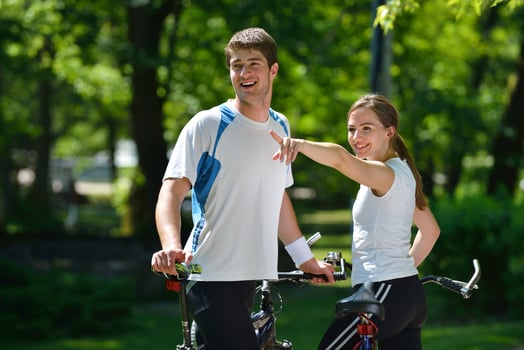 Happy couple riding bicycle outdoors photo