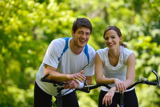 Happy couple ridine bicycle outdoors photo