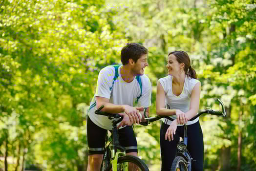 Happy couple riding bicycle outdoors photo