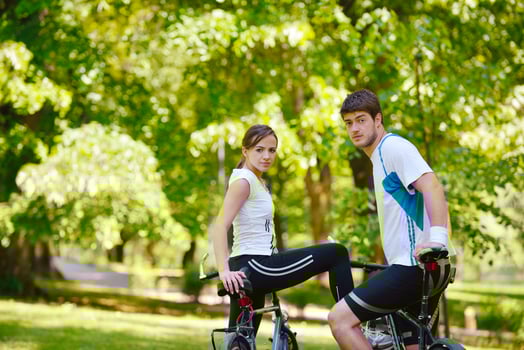 Happy couple riding bicycle outdoors photo