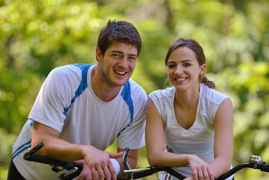 Happy couple ridine bicycle outdoors photo