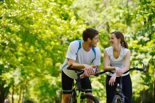 Happy couple riding bicycle outdoors photo