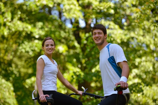 Happy couple ridine bicycle outdoors photo