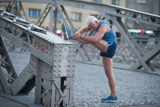 handsome man stretching before jogging photo