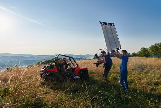 cameraman recording a young couple enjoying a buggy car  ride up a mountain photo