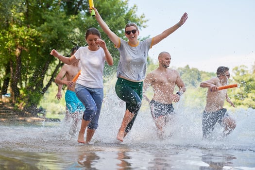 group of happy friends having fun on river photo