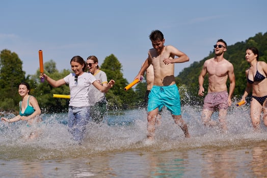 group of happy friends having fun on river photo