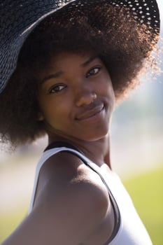 Close up portrait of a beautiful young african american woman smiling and looking up photo