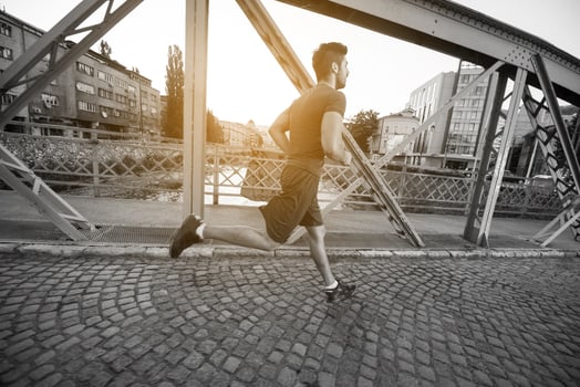 man jogging across the bridge at sunny morning photo