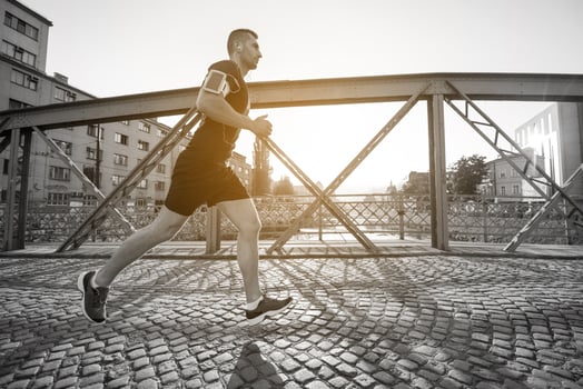 man jogging across the bridge at sunny morning photo