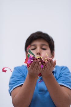 kid blowing confetti photo