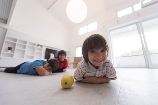 boys having fun with an apple on the floor photo