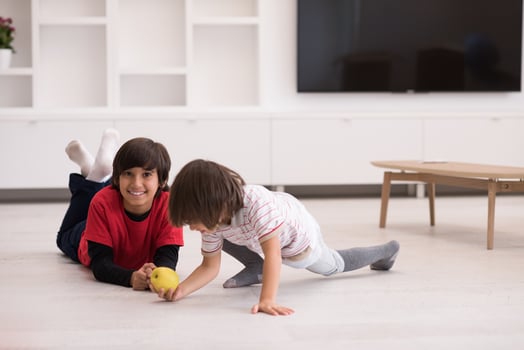 boys having fun with an apple on the floor photo
