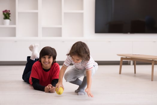 boys having fun with an apple on the floor photo