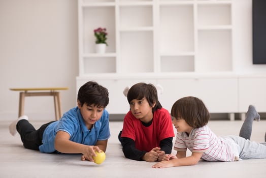 boys having fun with an apple on the floor photo