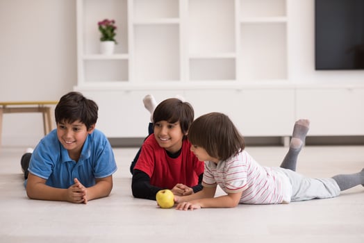 boys having fun with an apple on the floor photo