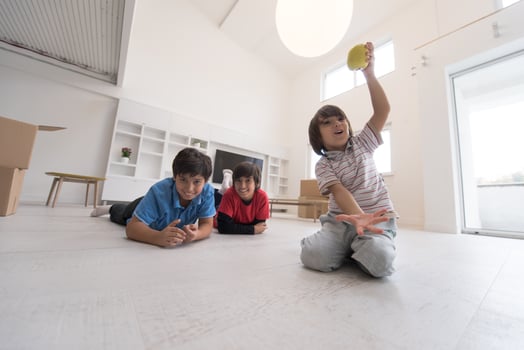 boys having fun with an apple on the floor photo
